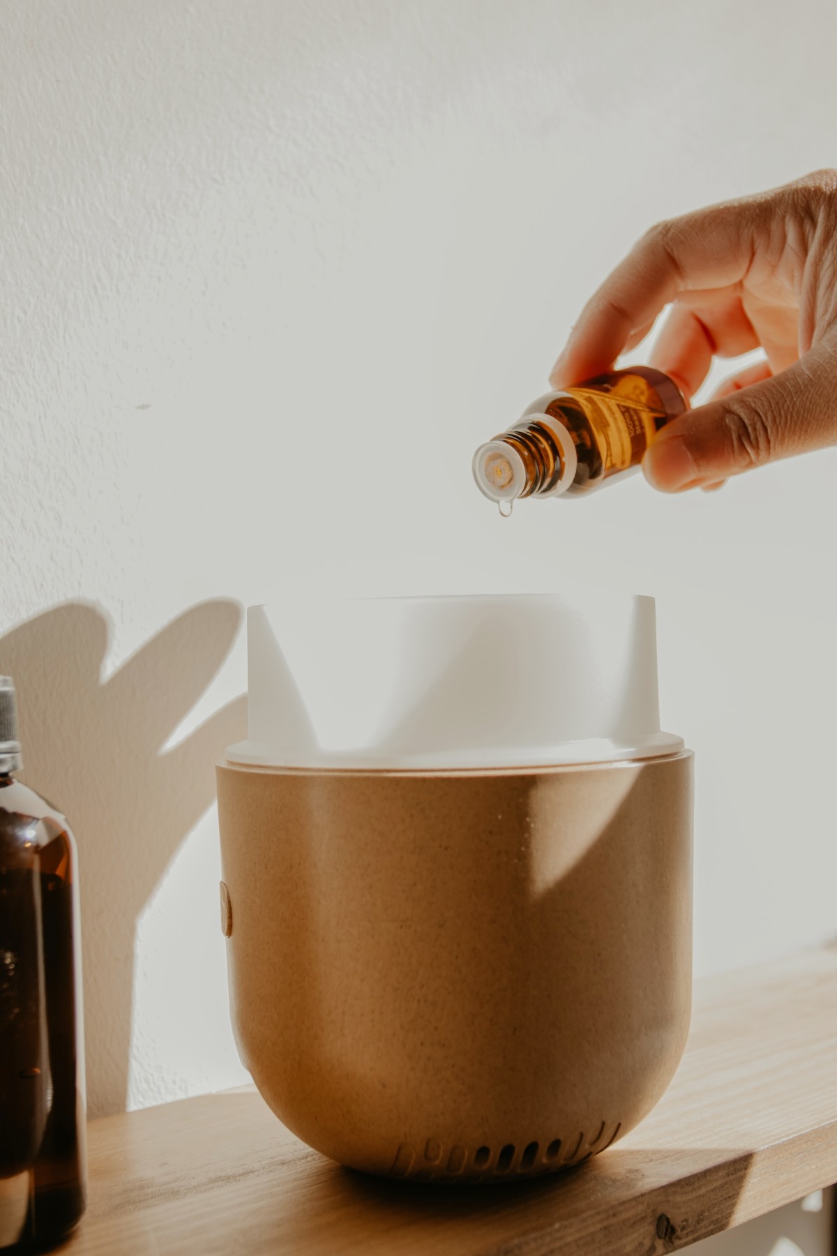 essential oil being dropped into diffuser