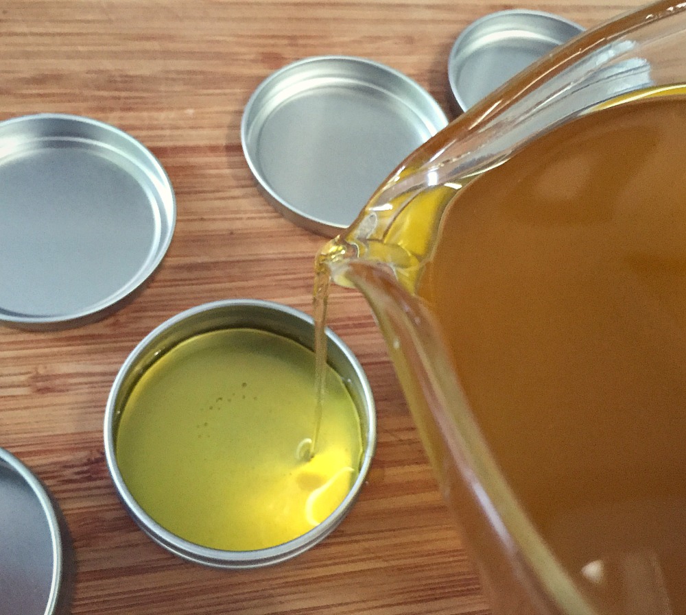 pouring salve into a tin