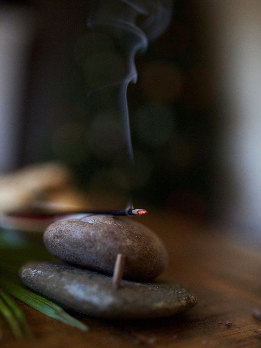 burning stick with smoke curling into the air