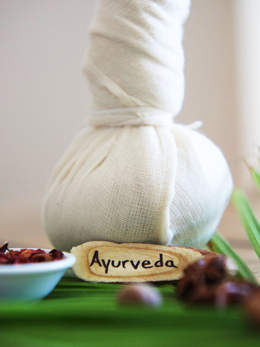 ayurveda towel with dried herbs on table