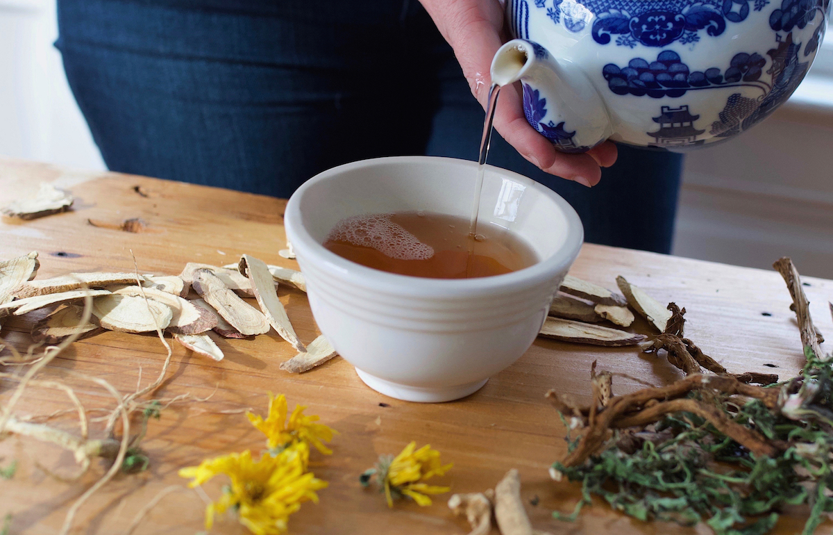 pouring tea into a mug