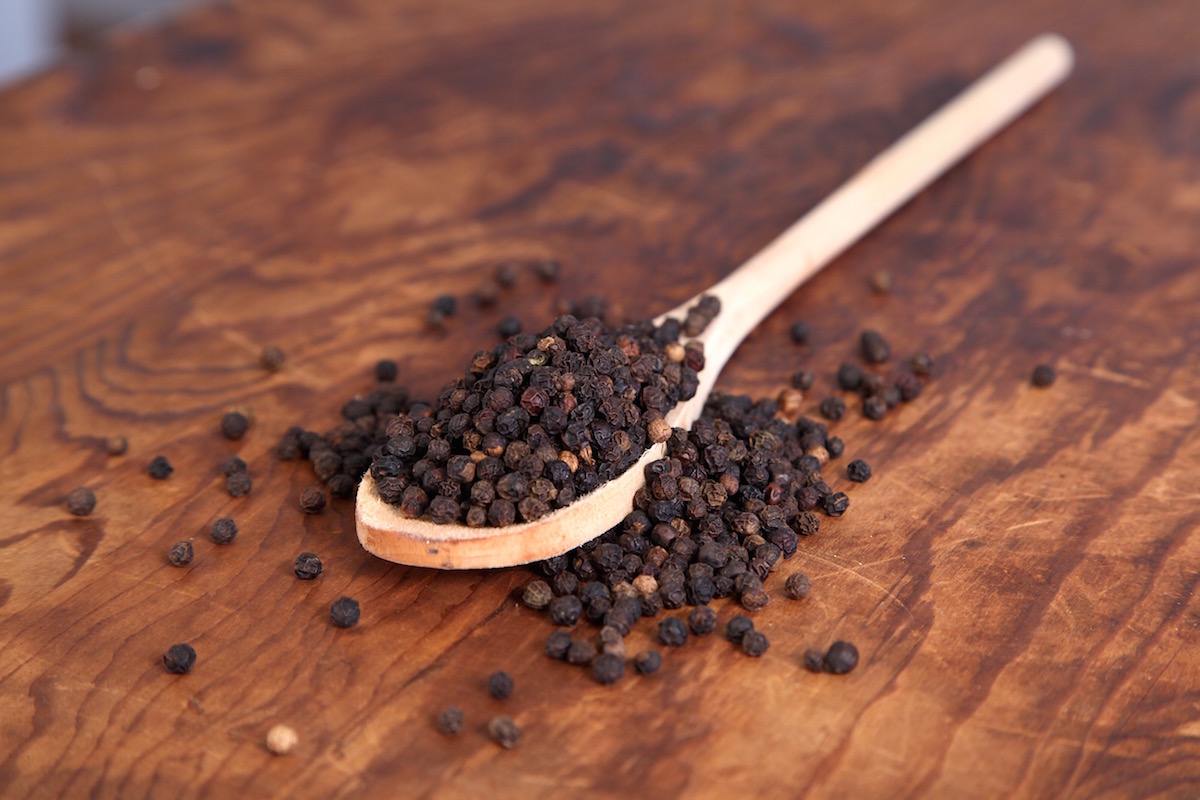 black pepper on a wooden spoon