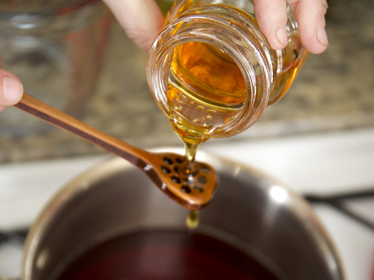 pouring honey through a spoon
