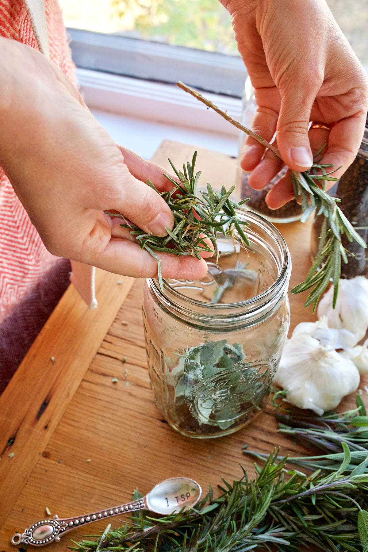 placing herbs in a jar