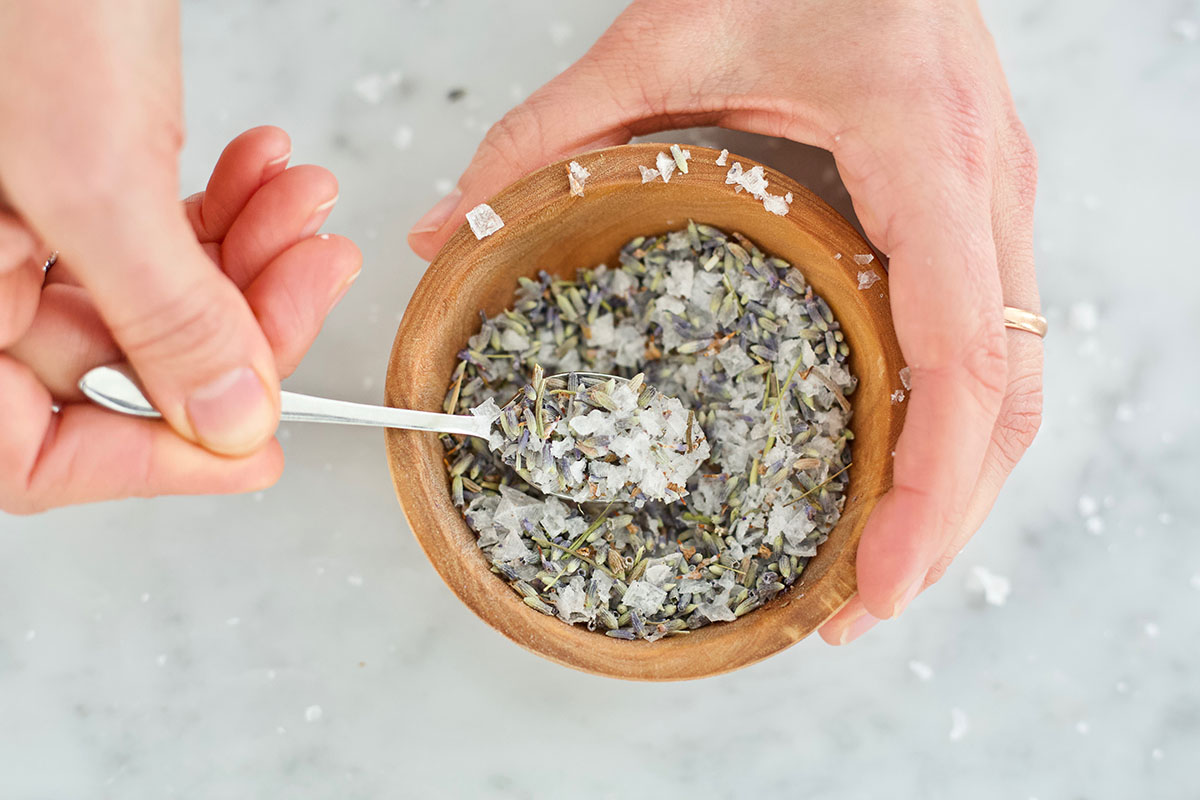 a small wooden bowl of herbs and salts