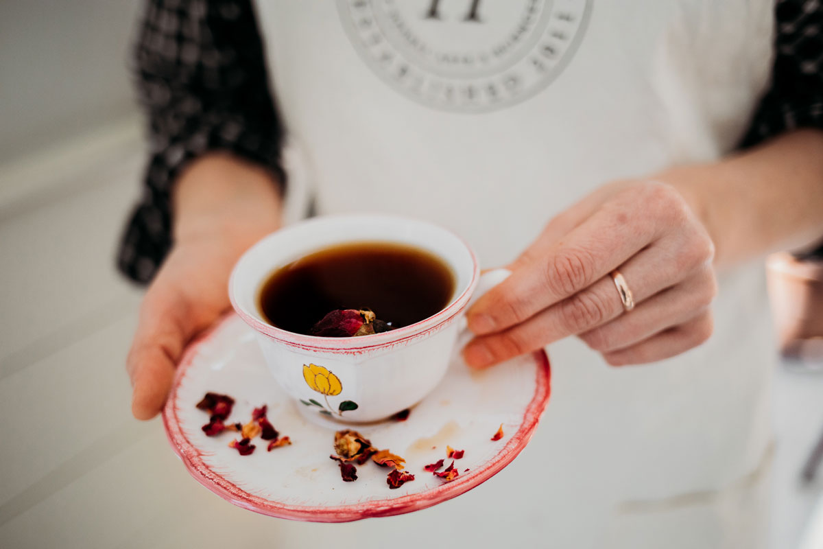 Woman Holding Cup of Red Tea