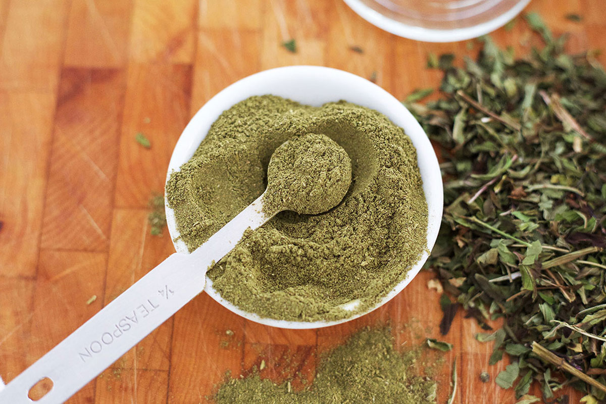 Powdered holy basil in bowl on table