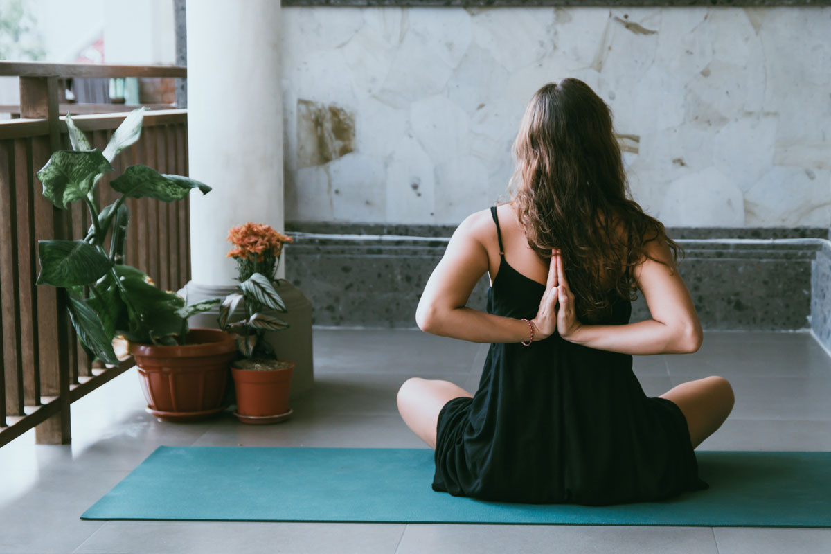 lady sitting on the floor doing a yoga pose