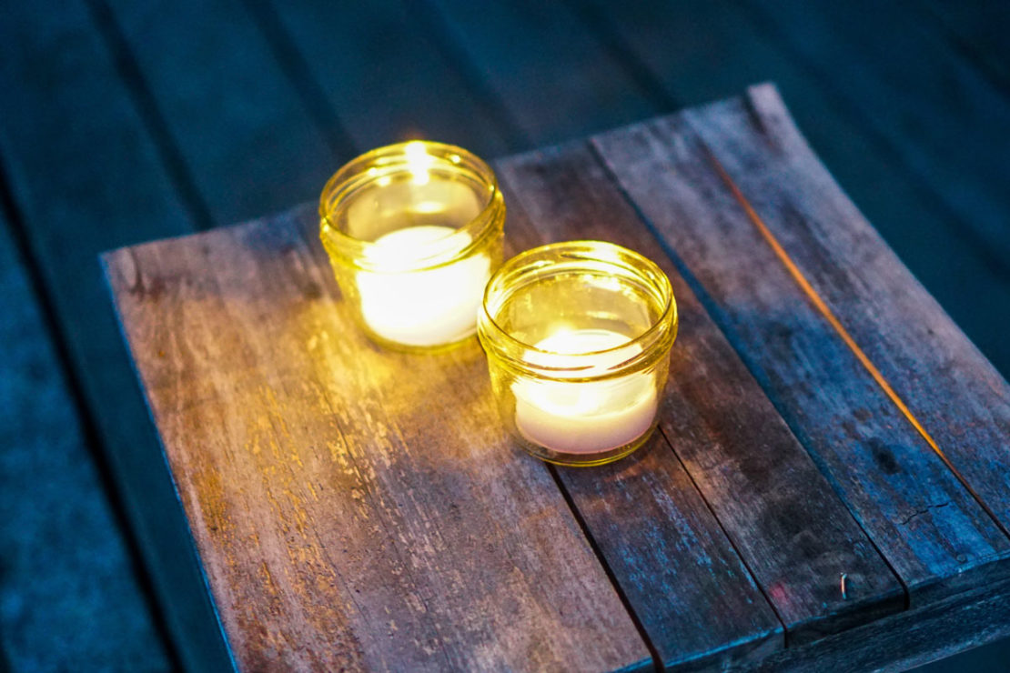 DIY Natural Citronella Candles | Herbal Academy | Learn how to make citronella candles from beeswax, essential oils, and dried herbs to repel mosquitoes, flies, and other insects.