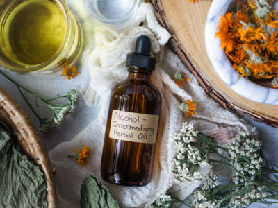 How to Make Alcohol Intermediary Herb-Infused Oils | Herbal Academy | With alcohol intermediary herb-infused oils you can save time, increase the shelf life of your oils, and create a stronger finished oil.