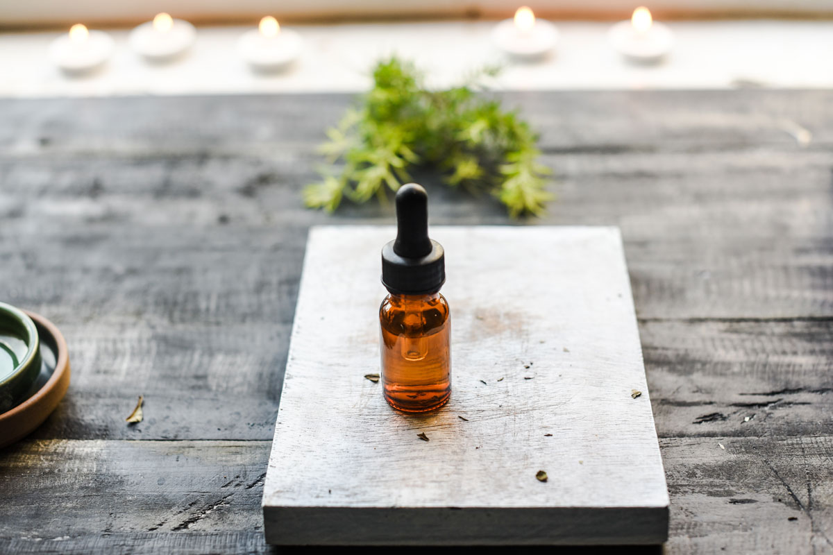 bottle of essential oil sitting on a table
