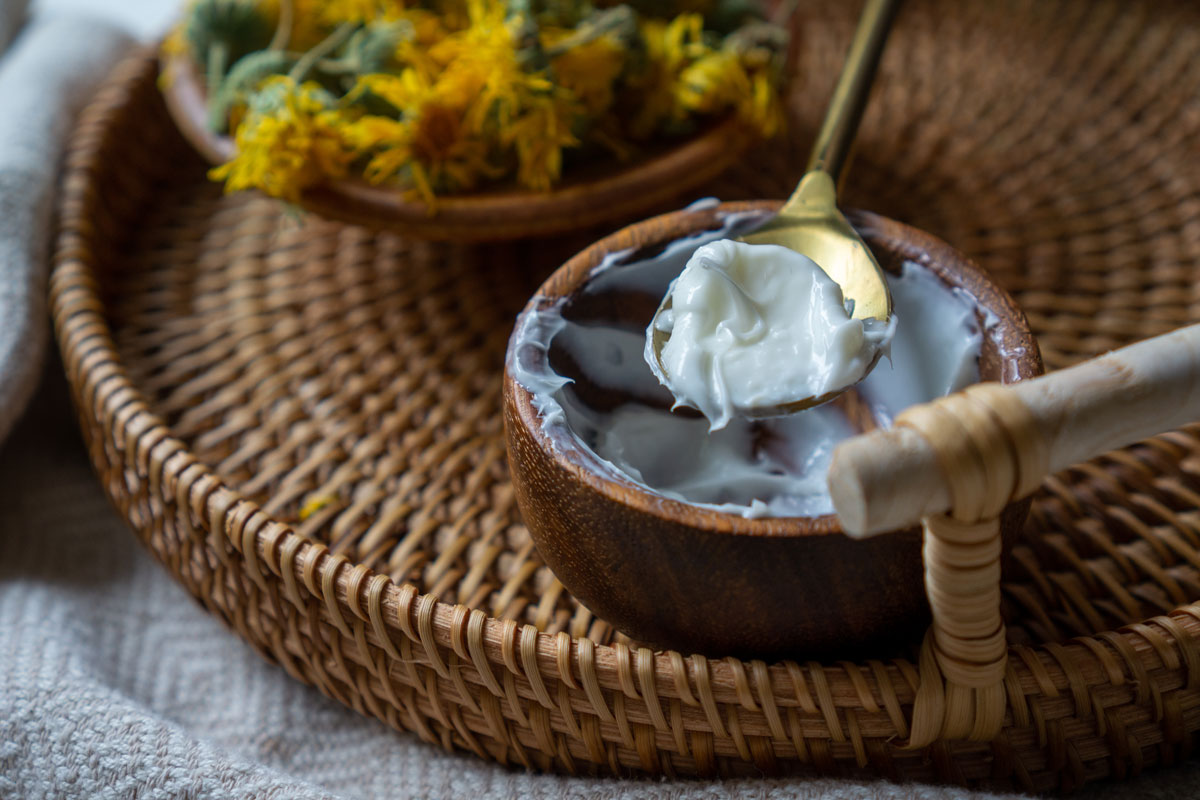 Calendula cream in a small wooden bowl