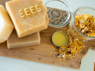 Homemade Nipple Balm with Marshmallow and Calendula | Herbal Academy | bees wax and flowers on table