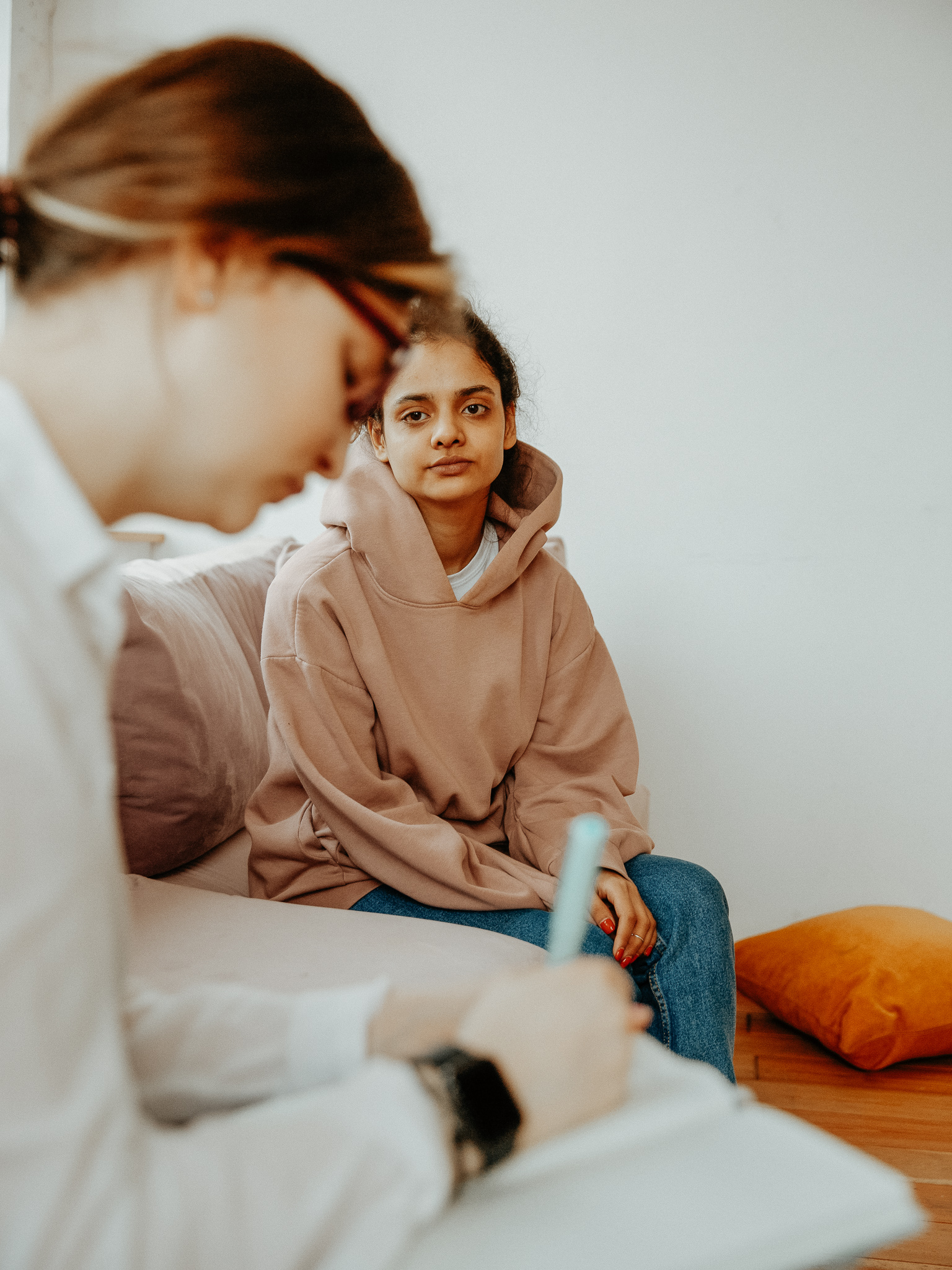 woman with female client writing down information 