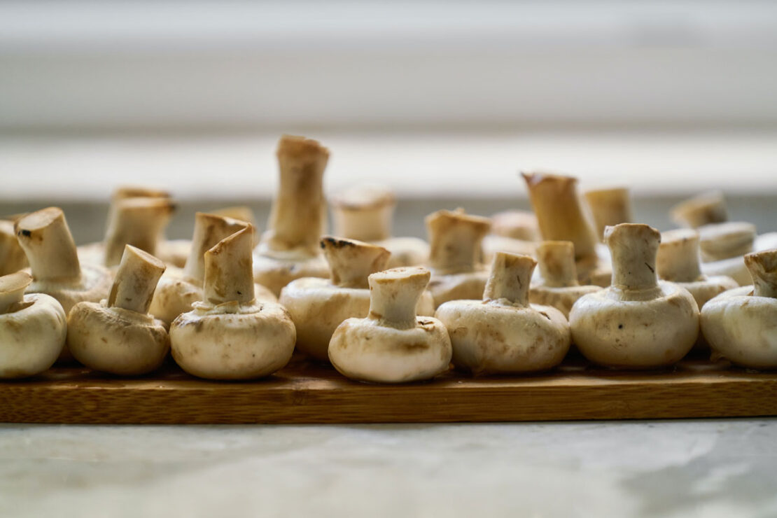 button mushrooms on a cutting board