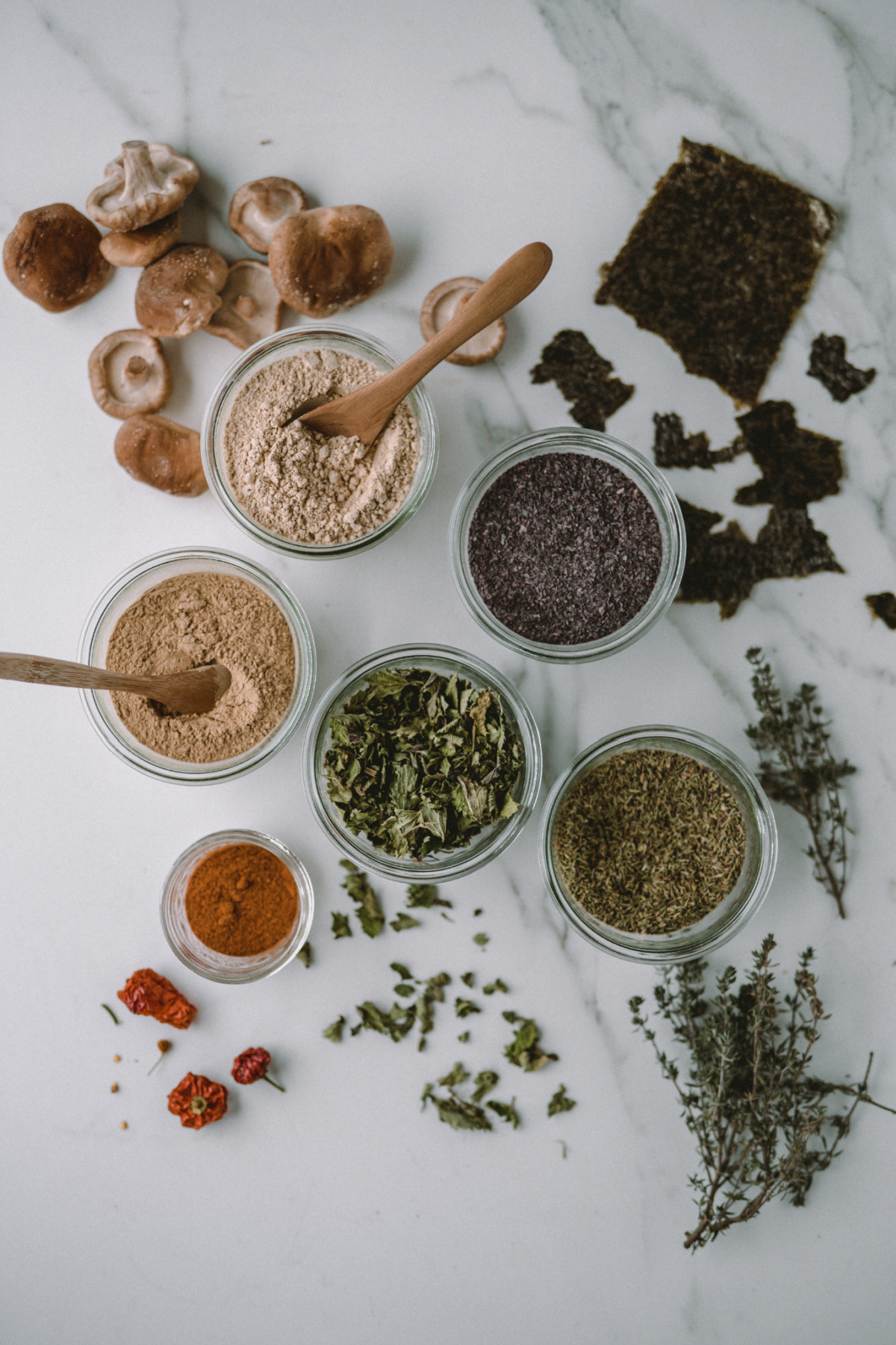 dried herbs in bowls on a table