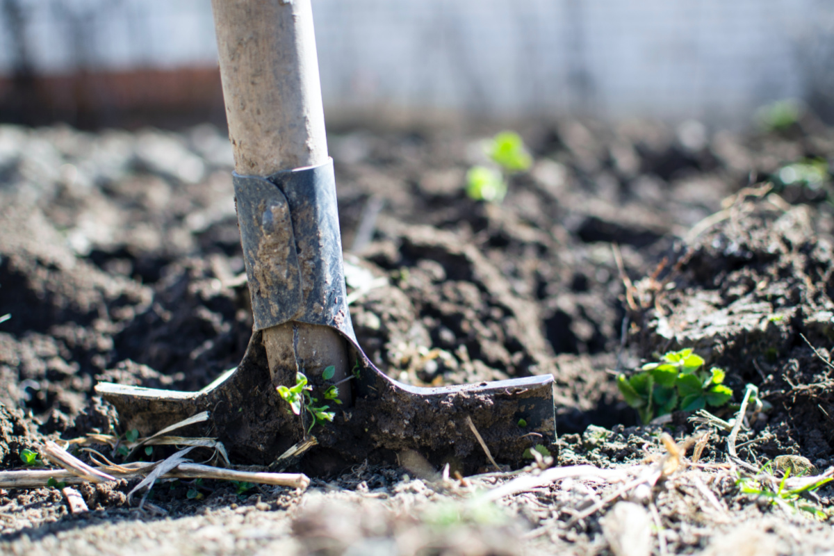 a shovel digging into the dirt