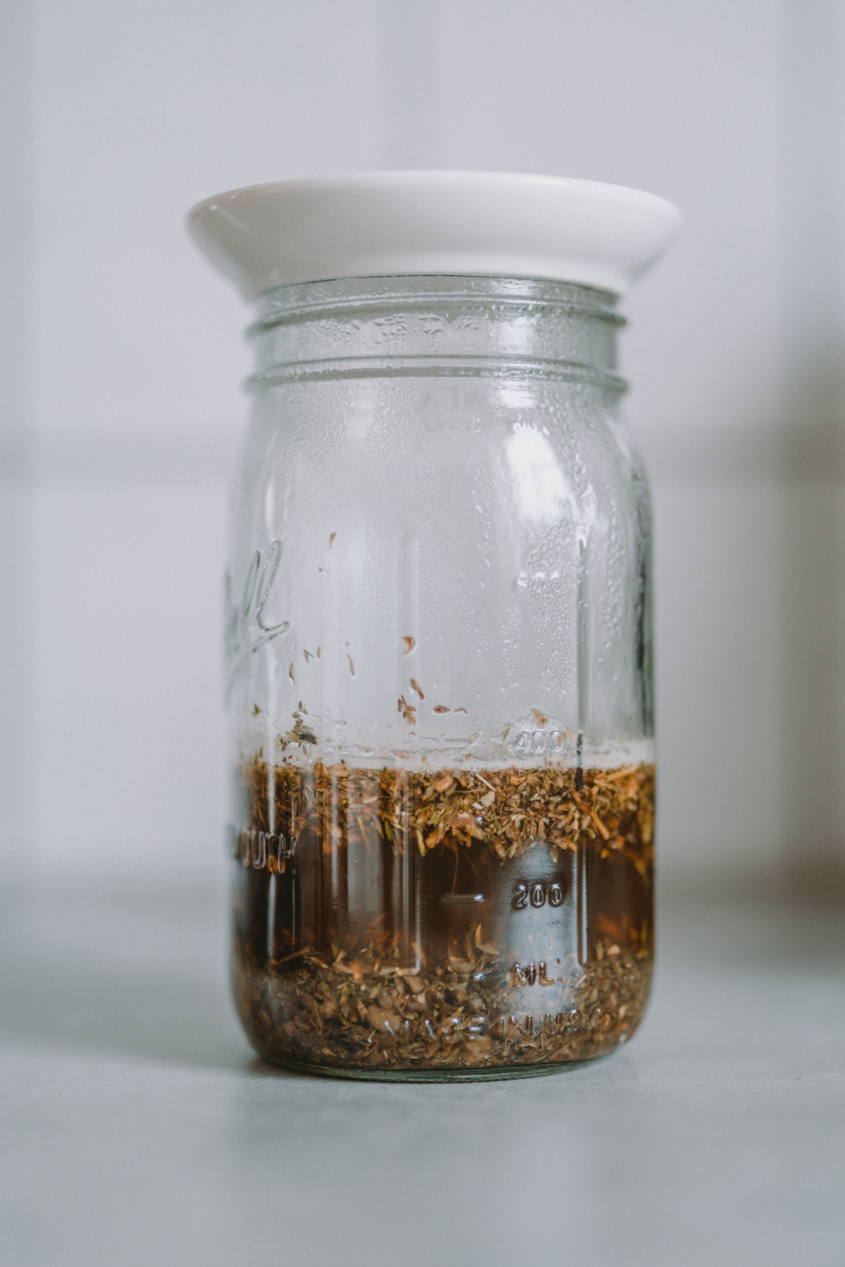 covered jar of infused herbs