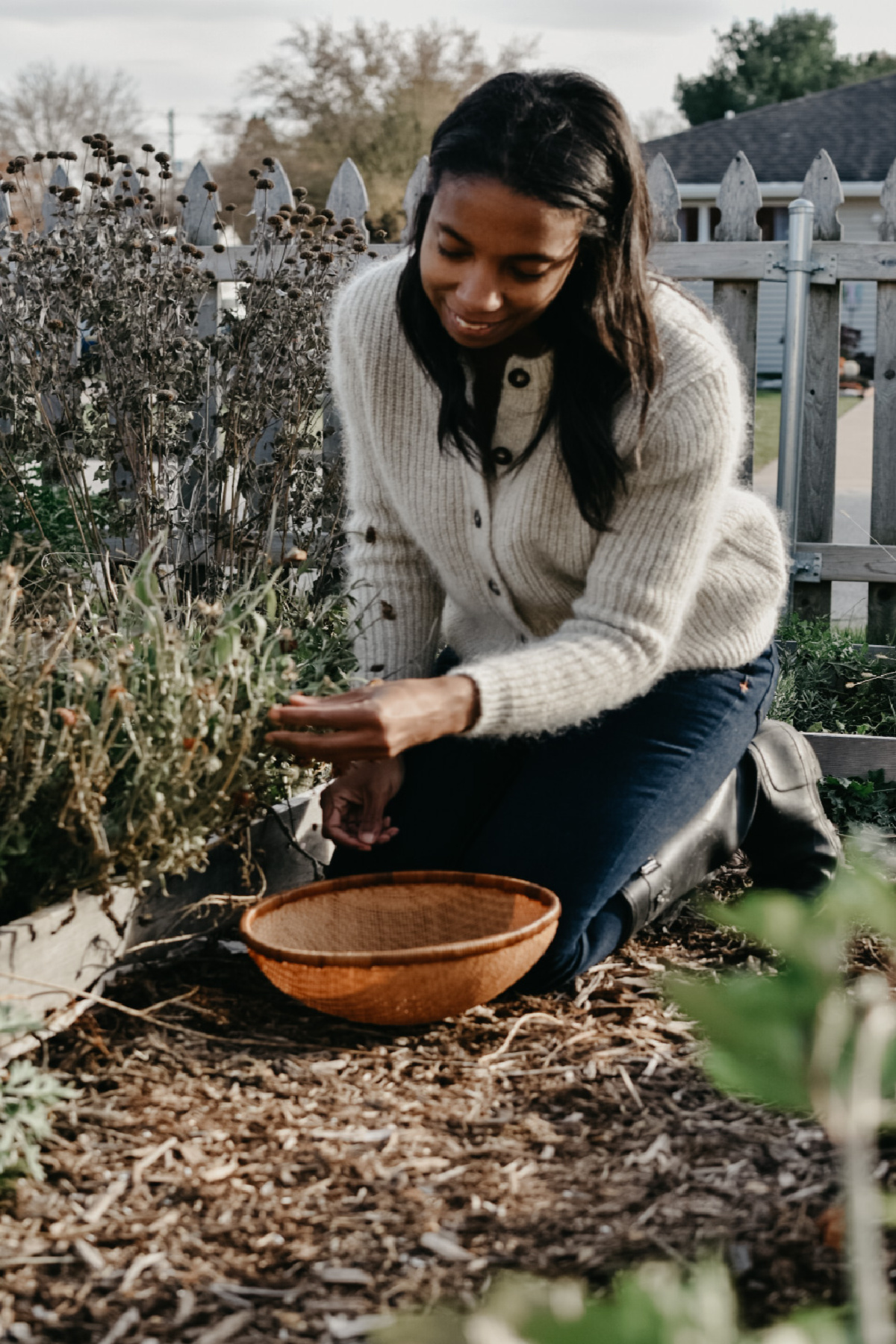 herbalist connecting with an herb in her garden