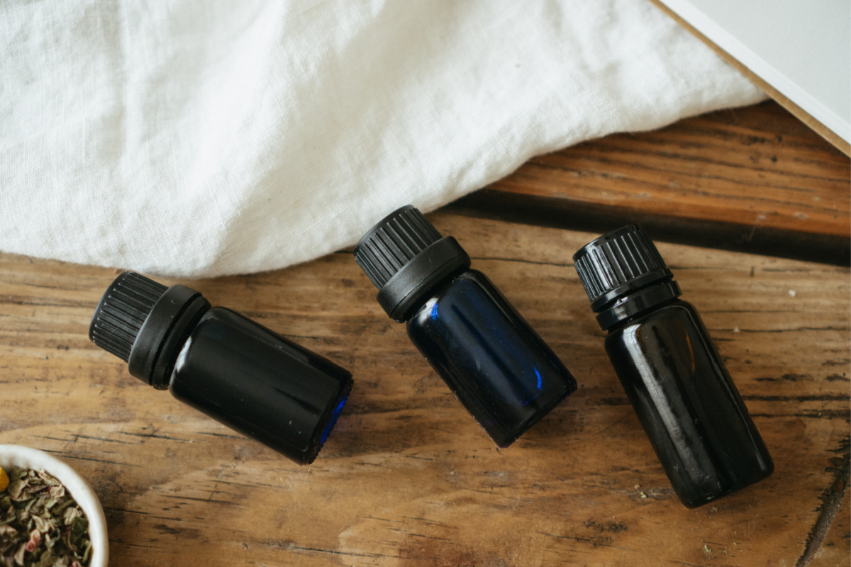 essential oil bottles laying on wooden table