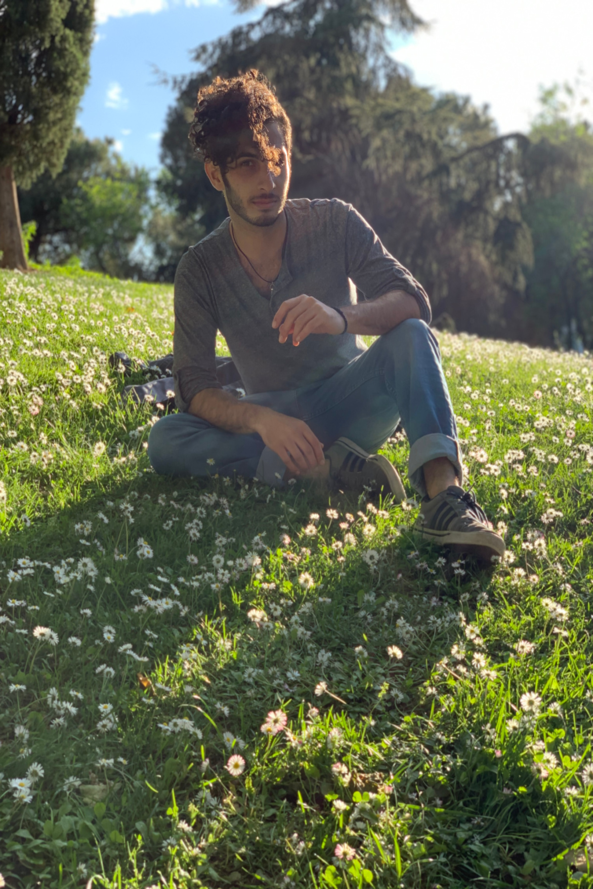 herbalist sitting on a hill of flowers