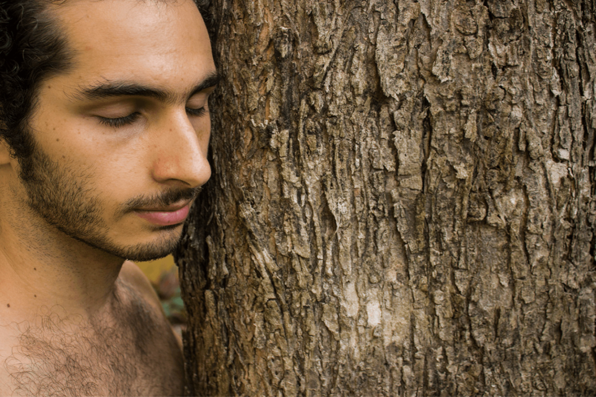 herbalist Eduardo Yunen next to a tree