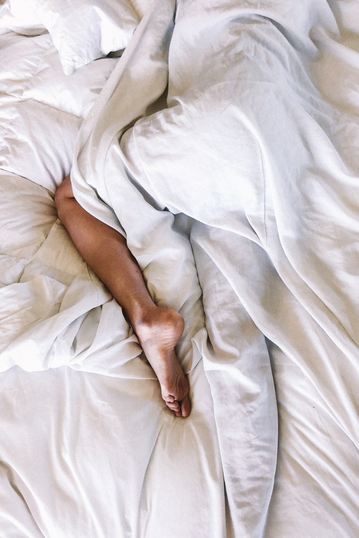 woman sleeping under covers