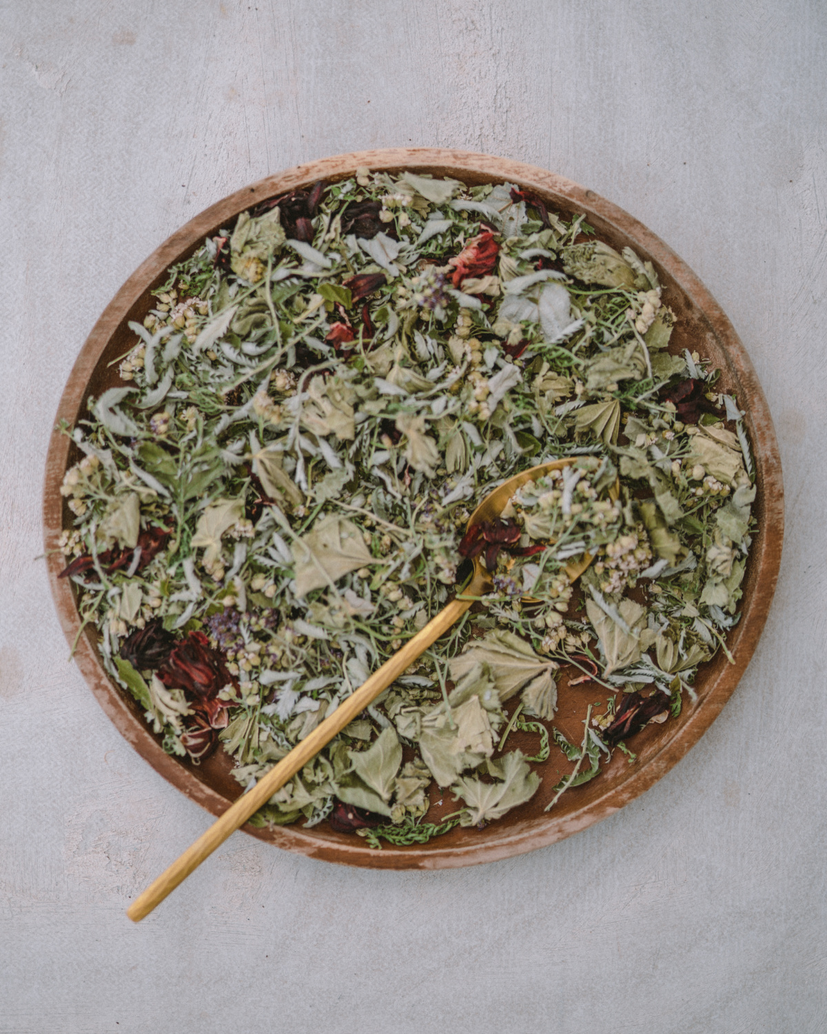 dried herbs in a wooden bowl ready to make Moon Tea