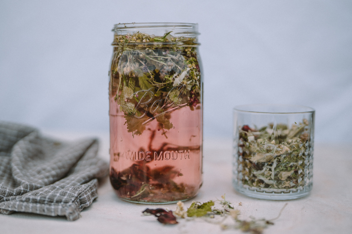 herbs infusing in a jar to make Moon Cycle Tea 