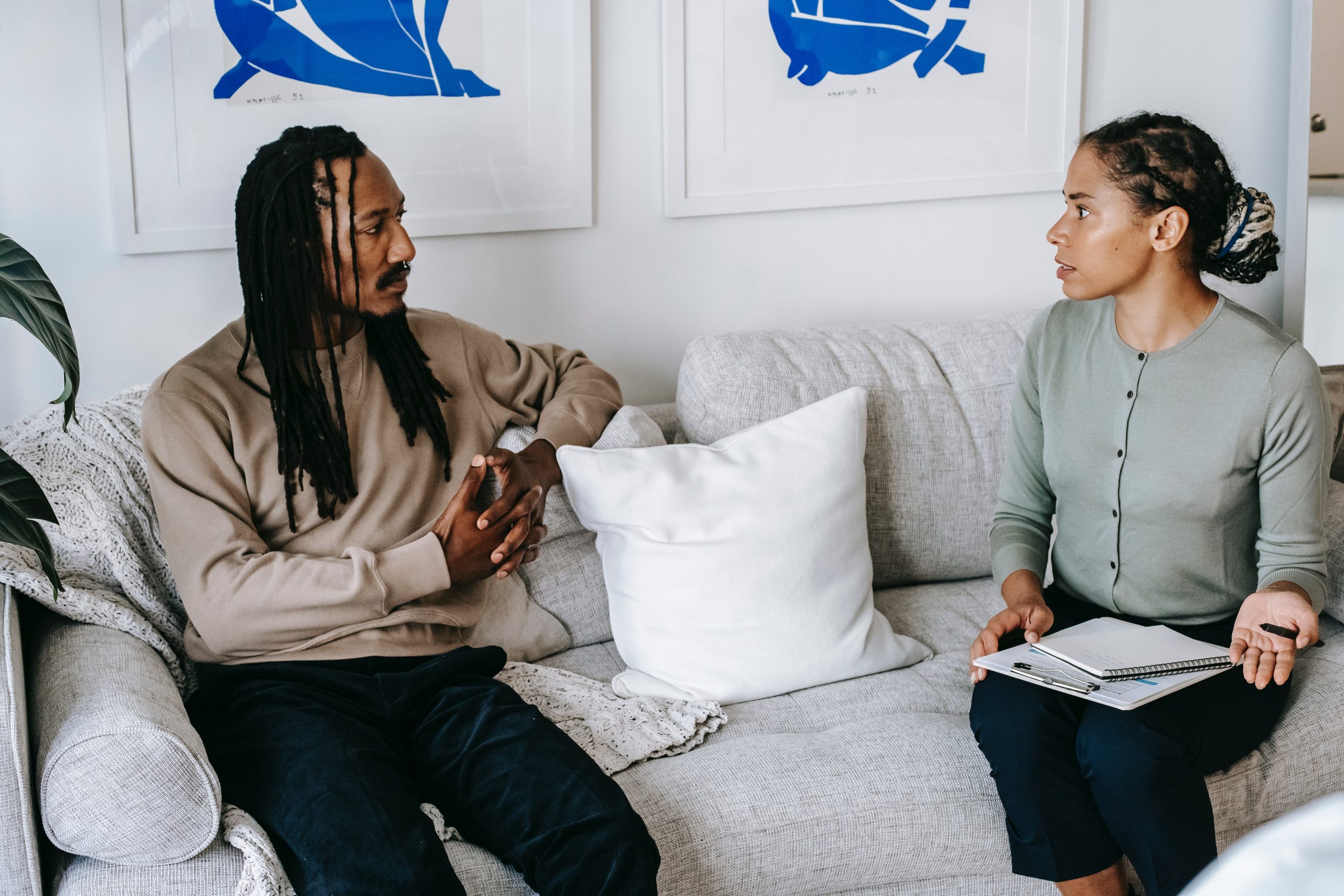 woman speaking to a client sitting on a couch