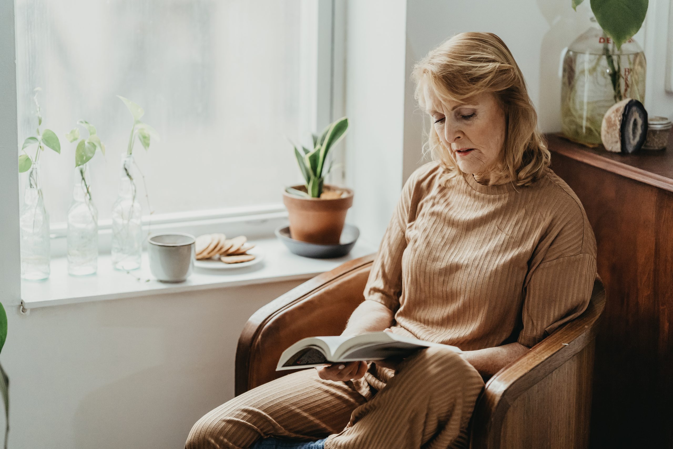 woman sitting in a chair reading