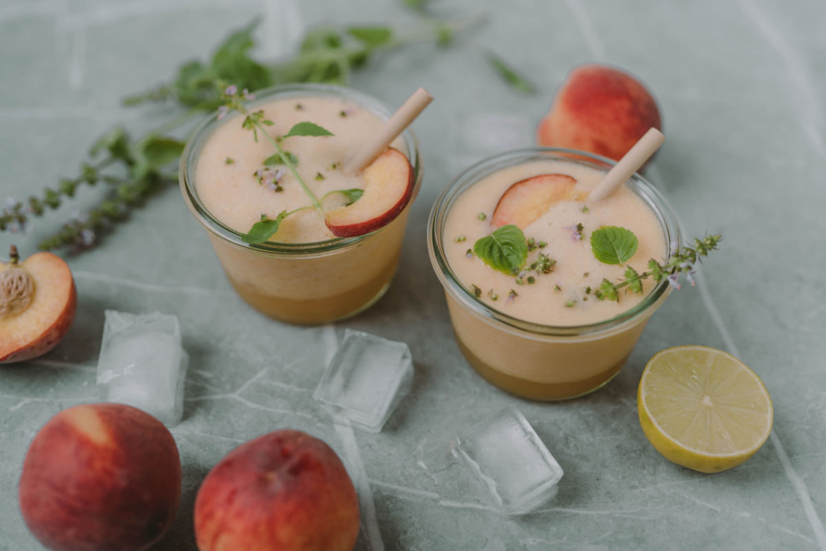 holy basil-peach drink in cups with straws