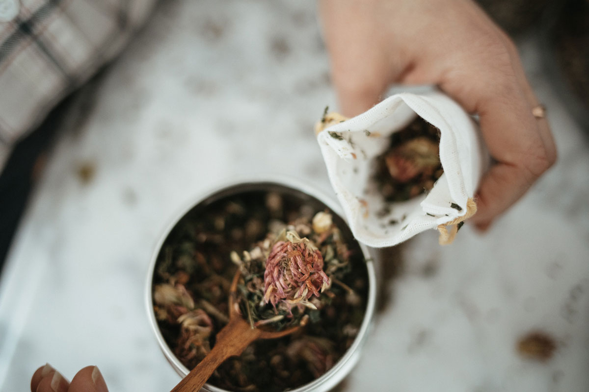 filling a tea bag with herbs