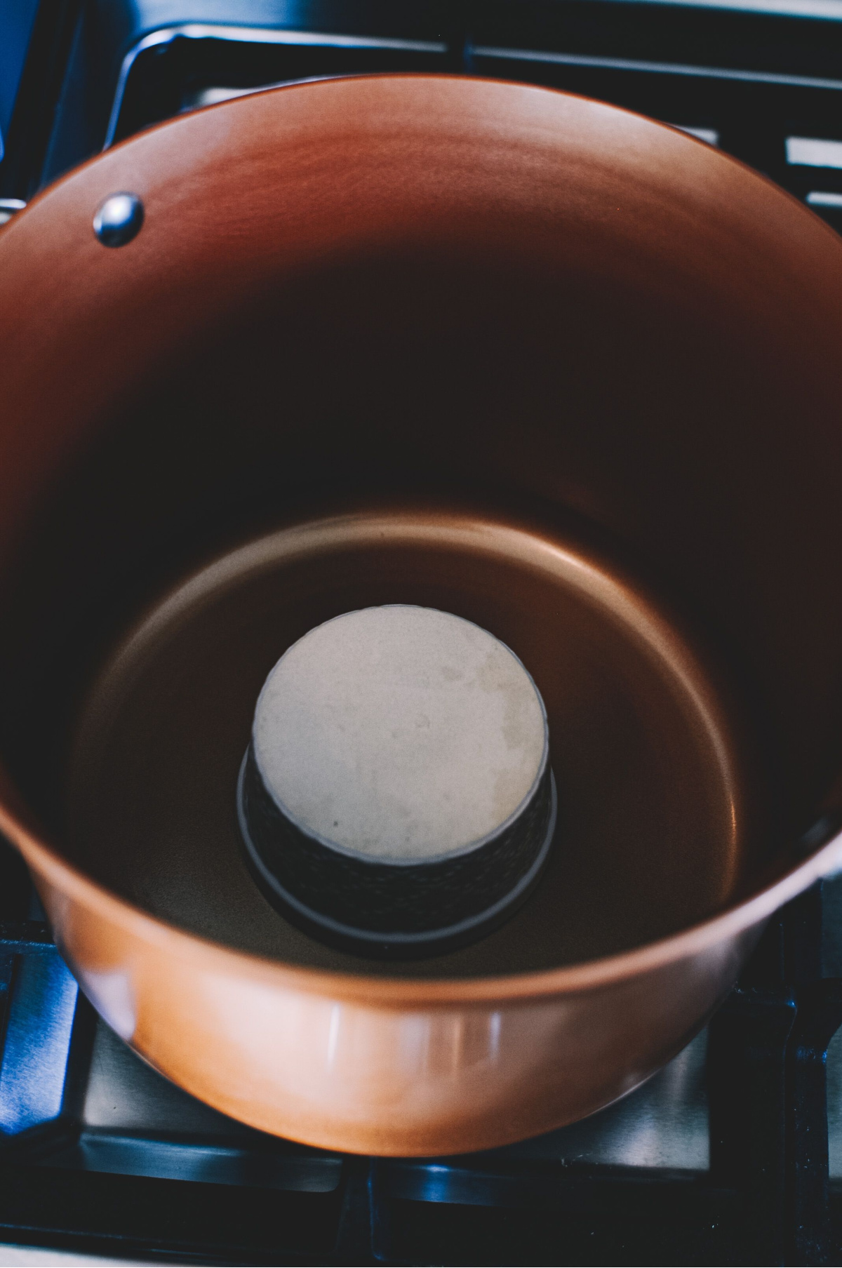 ramekin sitting upside down in a large pot