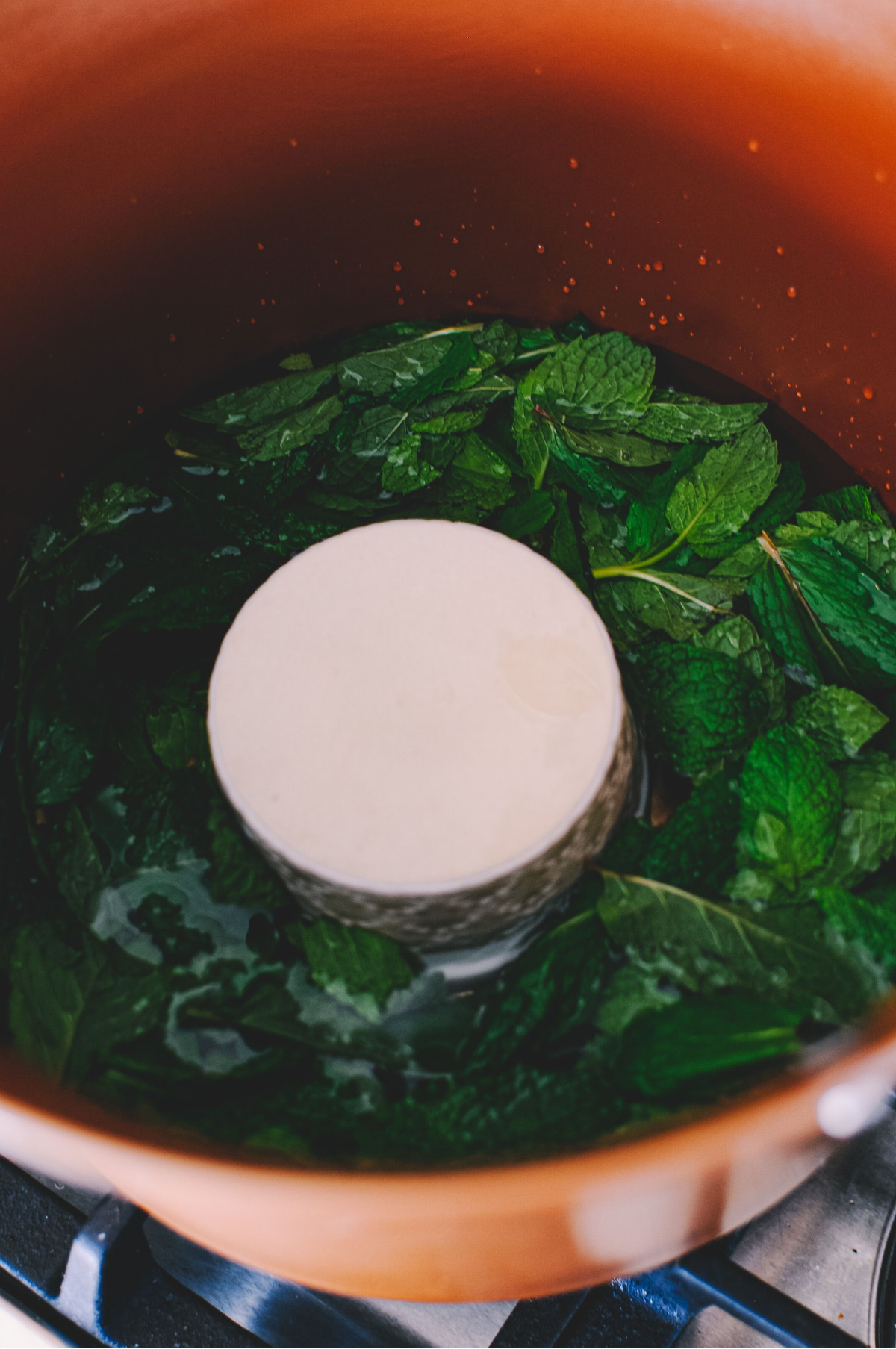 mint leaves floating in a pot of water