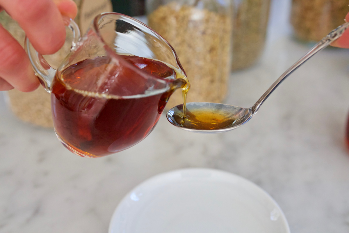 pouring honey onto a spoon