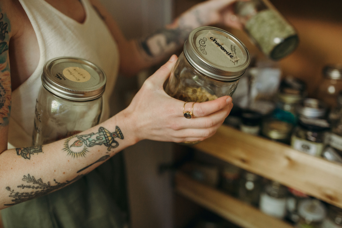 holding jars of dried herbs