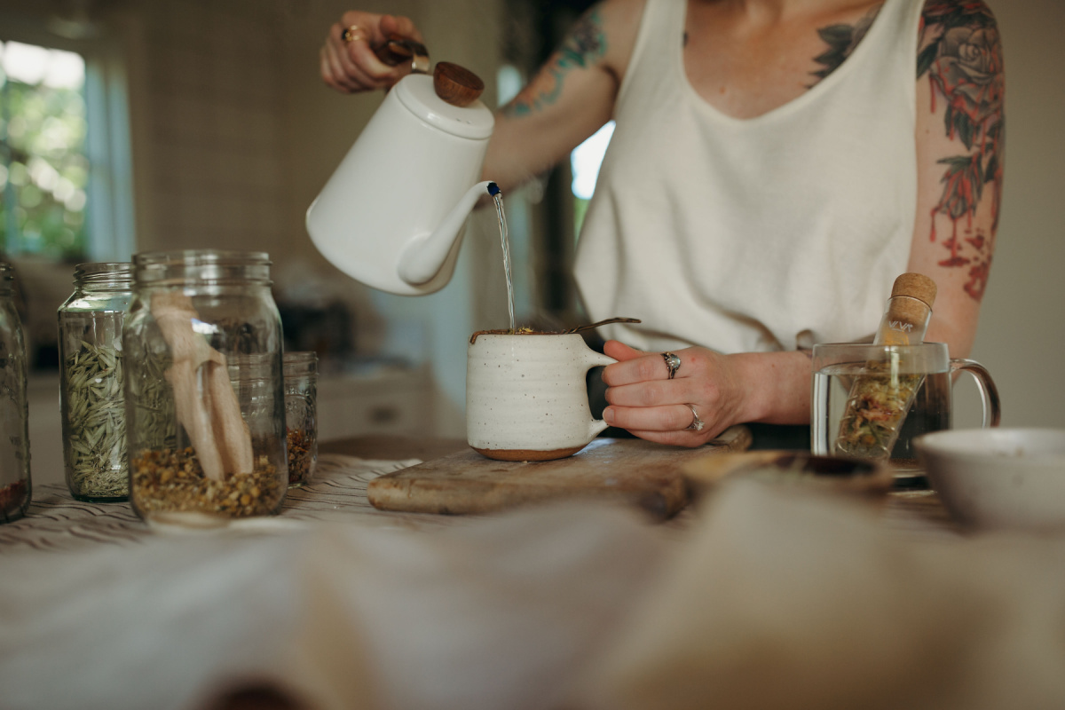 pouring hot water from a tea kettle