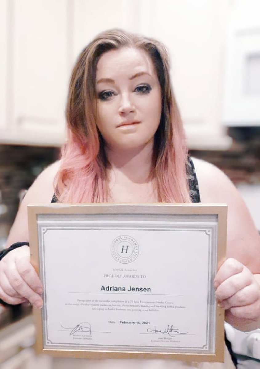 Adriana Jensen holding Herbal Academy certificate