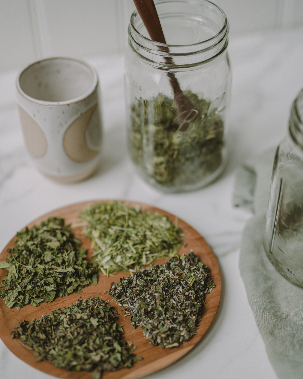 herbs for pregnancy tea in jar and on wodden platter