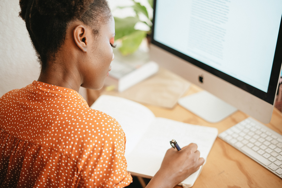 woman writing in a notebook 