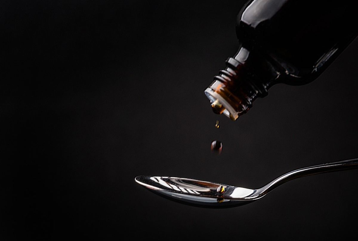 cough syrup dripping on a spoon