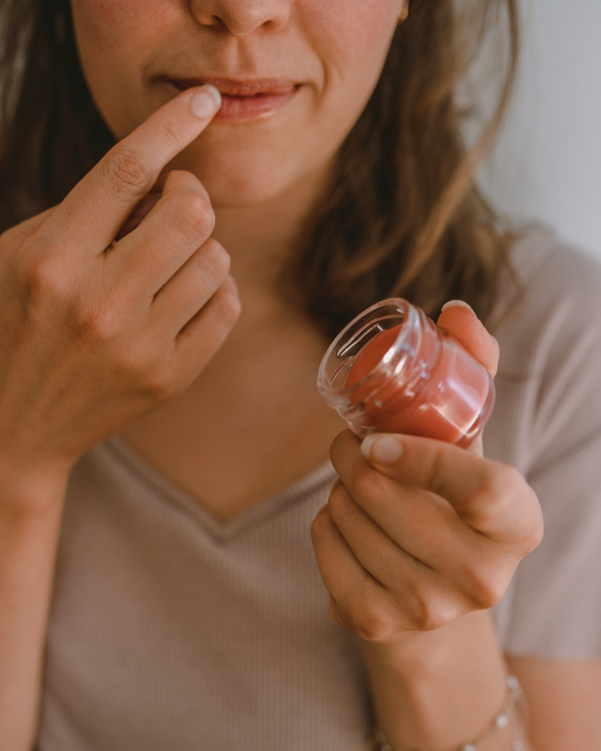 woman applying lip balm