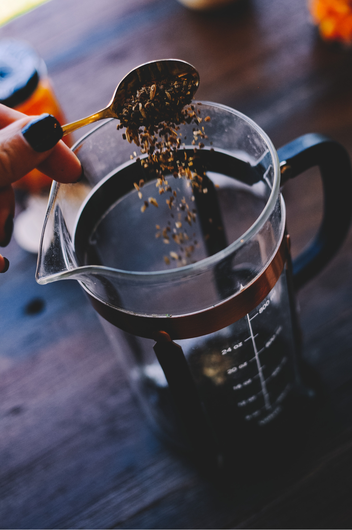 pouring herbs into a french press