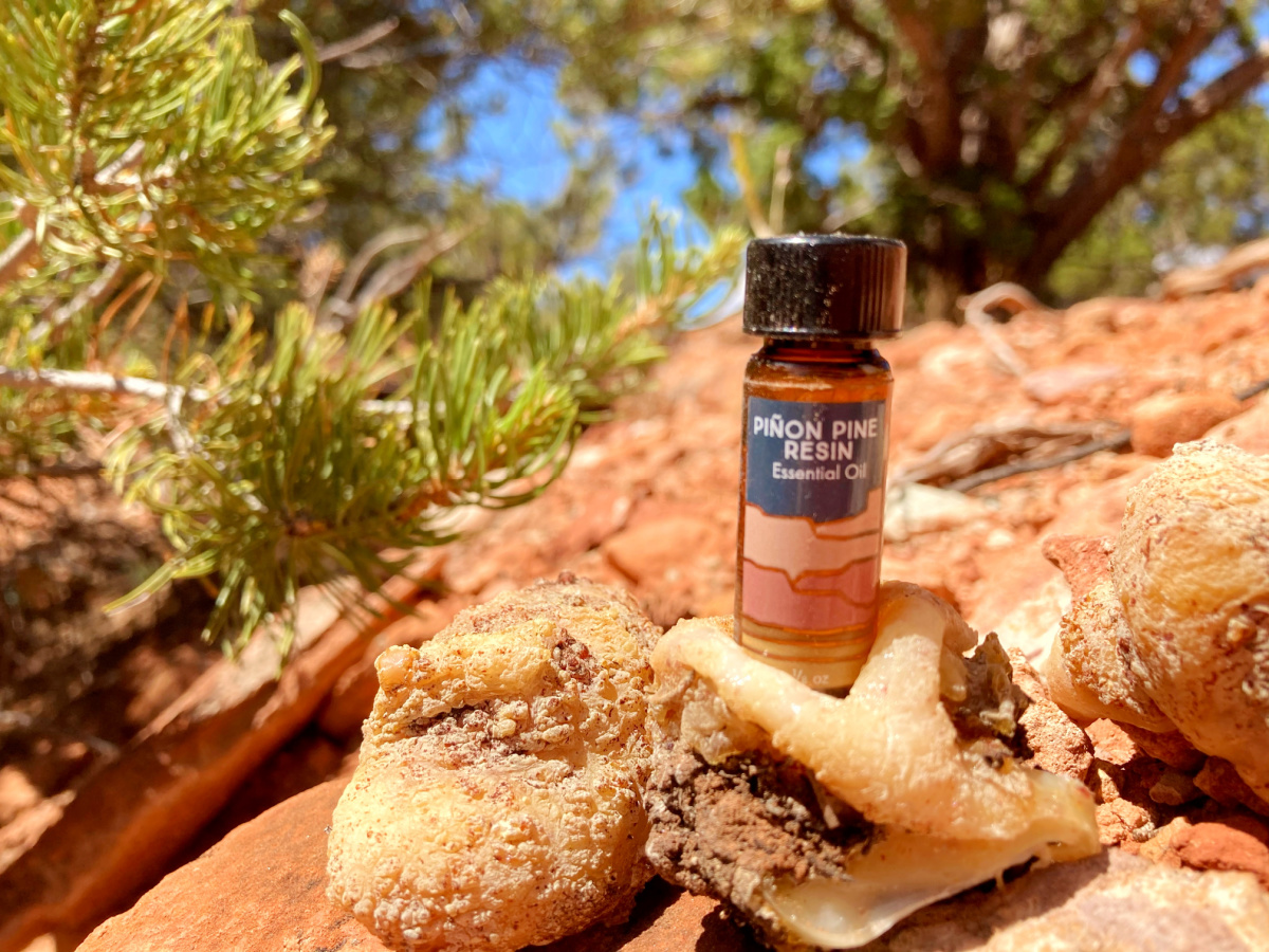 pine resin essential oil bottle sitting on a rock