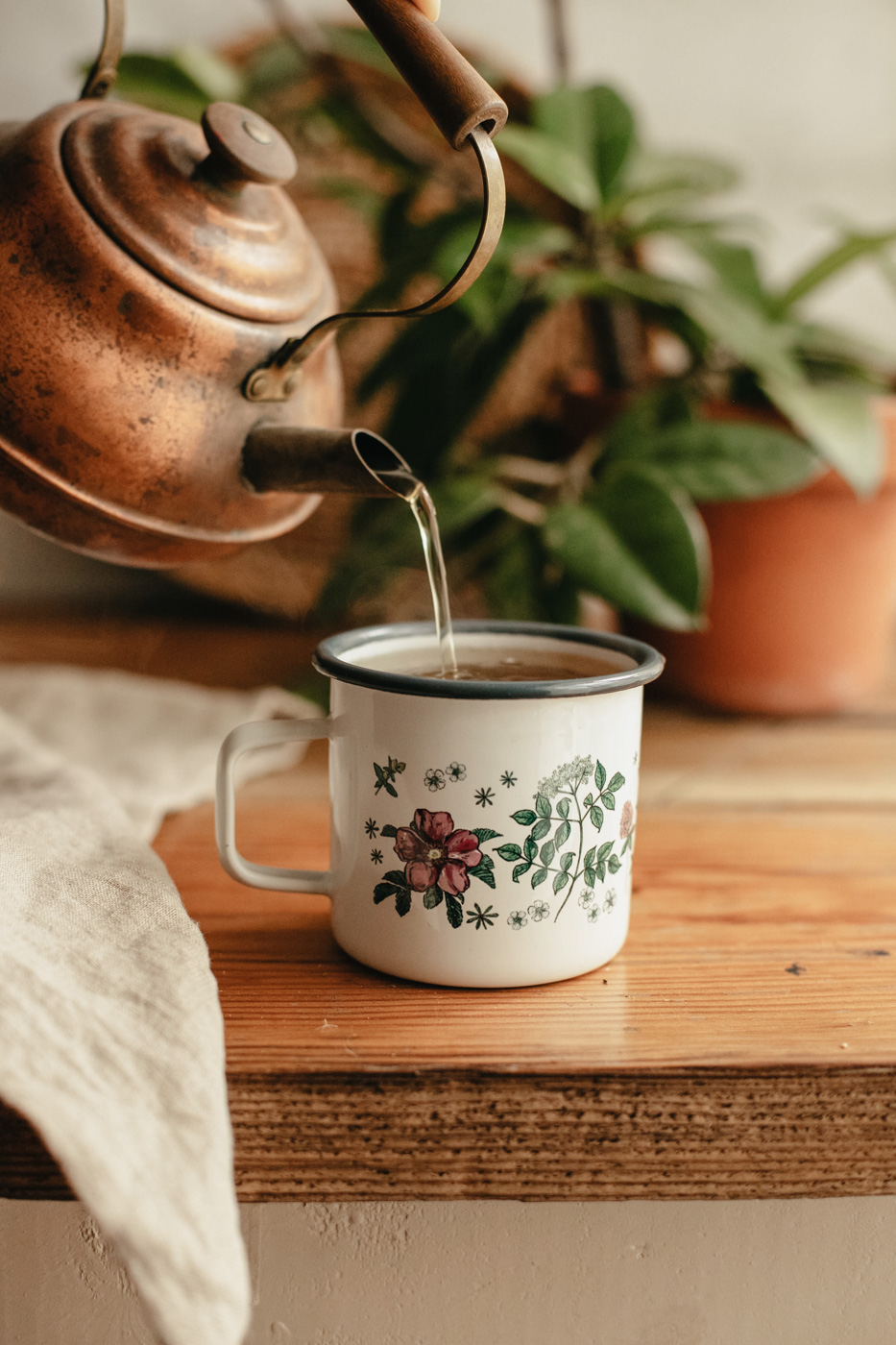 pouring water into an Herbal Academy mug