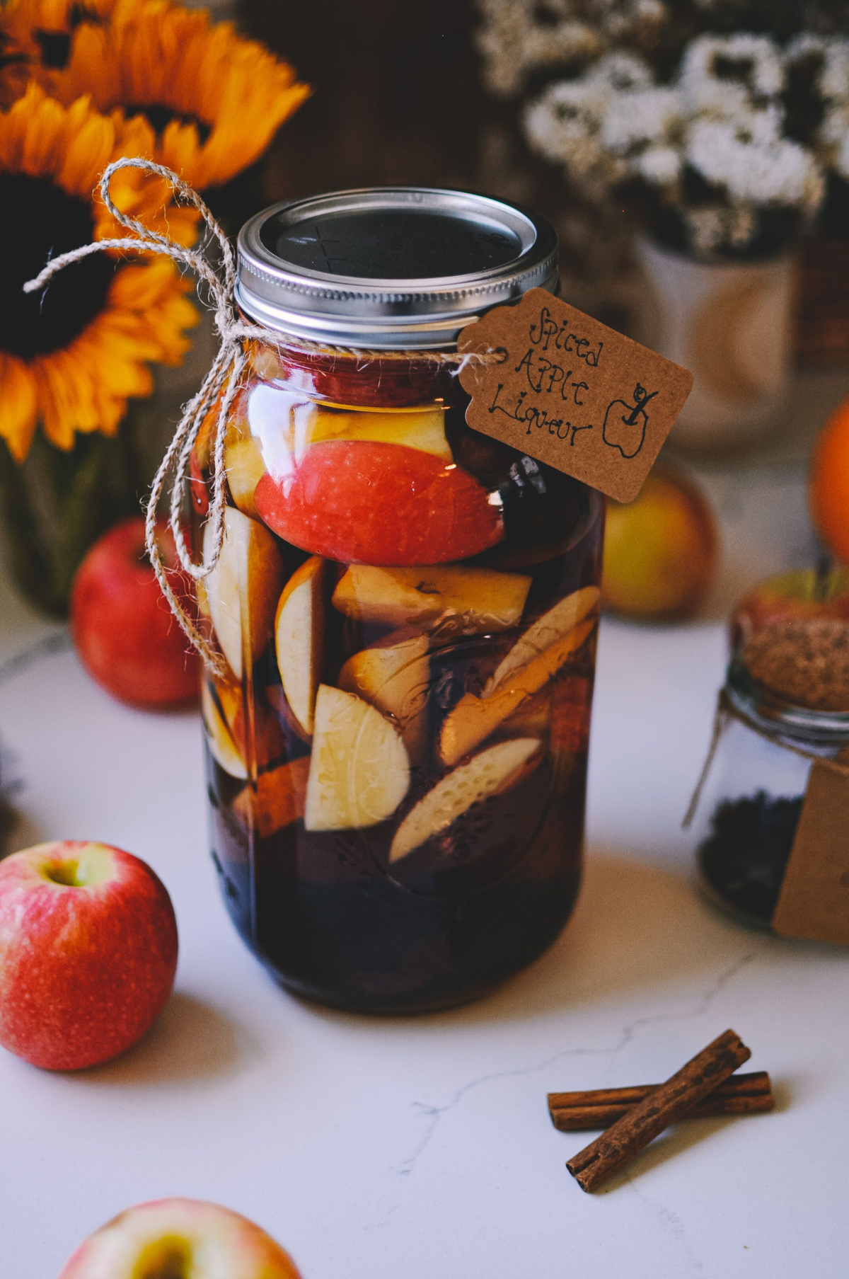 spiced apple liqueur in a jar with a label