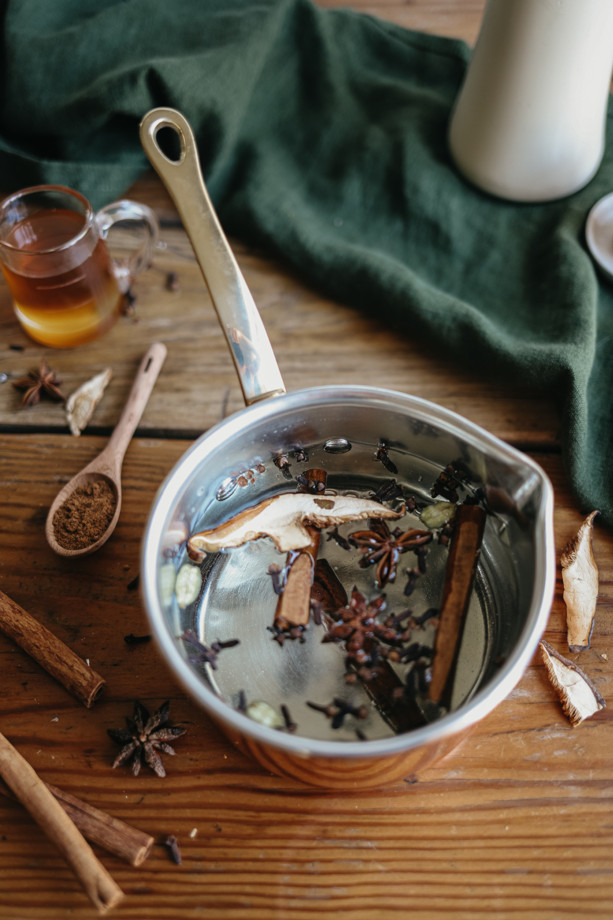 pan of water and herbs to make chai syrup