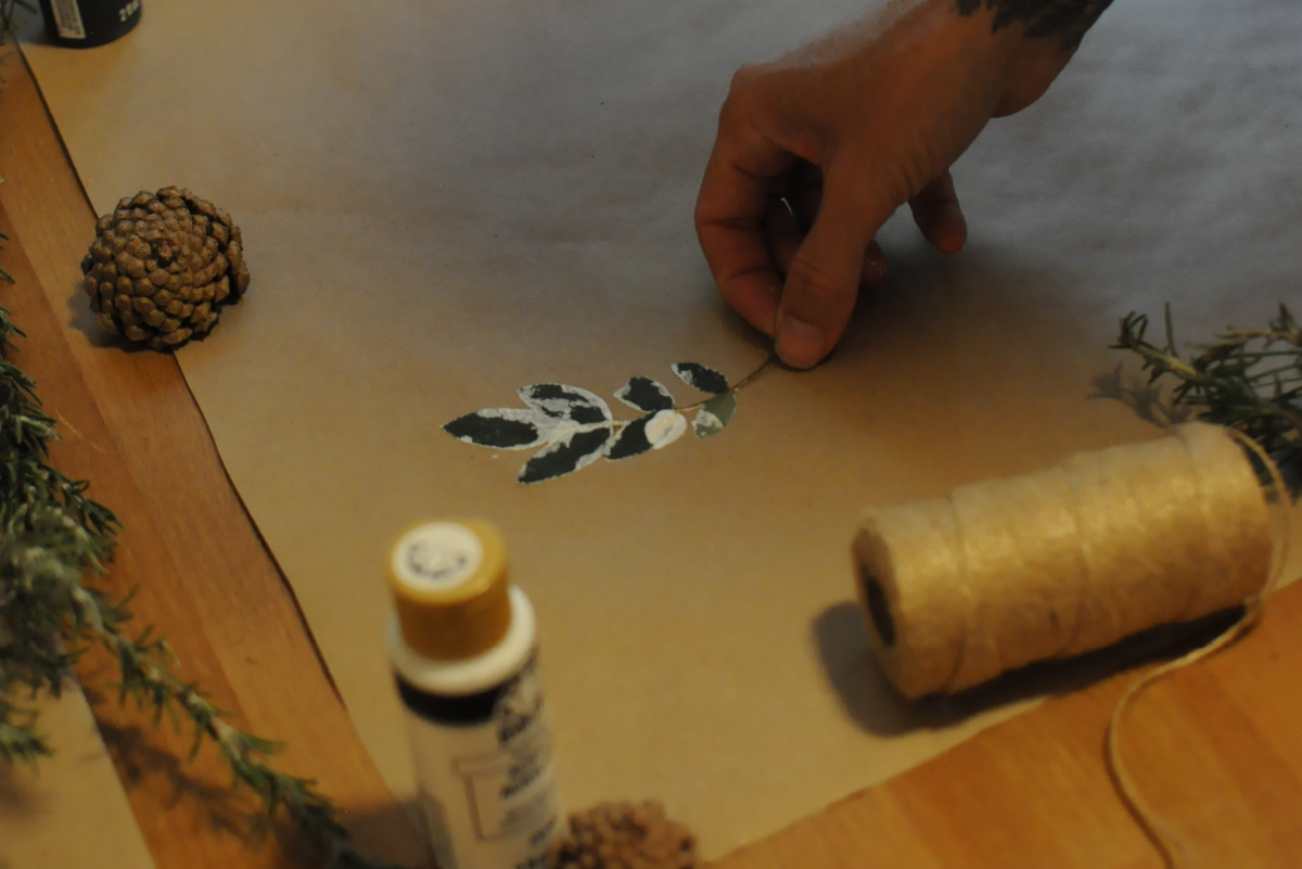 pressing painted leaf onto paper