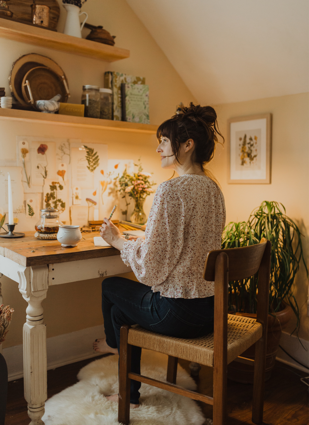 herbalist sitting at a desk with pen and paper